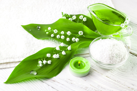 Spa still life of sea salt and essential oils and lily of the valley flowersの写真素材