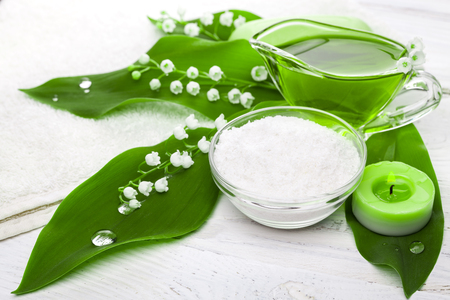 Spa still life of sea salt and essential oils and lily of the valley flowersの写真素材