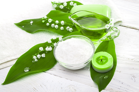 Spa still life of sea salt and essential oils and lily of the valley flowersの写真素材