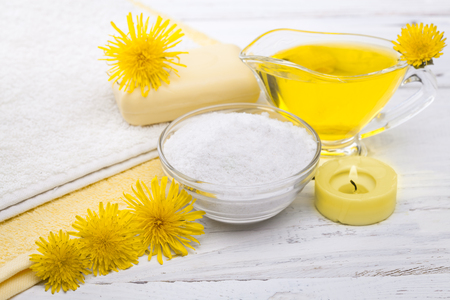 Spa still life of sea salt and essential oils and dandelion flowersの写真素材