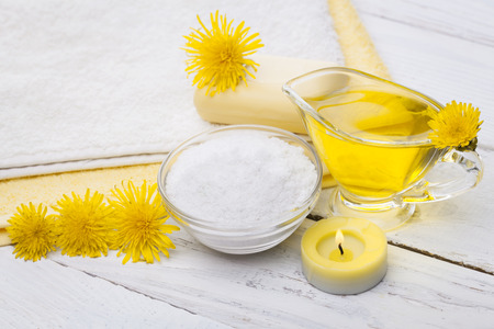 Spa still life of sea salt and essential oils and dandelion flowersの写真素材