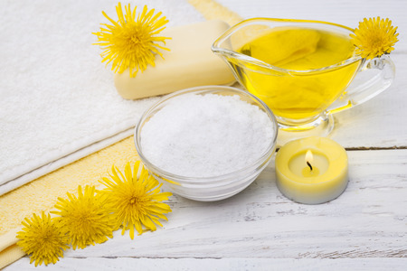 Spa still life of sea salt and essential oils and dandelion flowersの写真素材