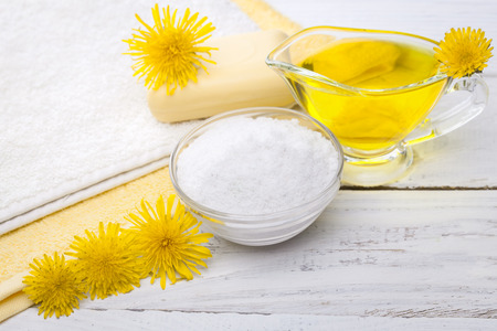 Spa still life of sea salt and essential oils and dandelion flowersの写真素材