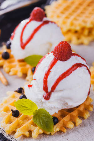 Vanilla Ice Cream with Mint and waffles. Homemade Organic product. On the black wooden table.の写真素材