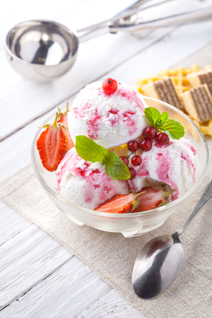 Ice Cream with Strawberry, Mint and waffles. Homemade Organic product. On the white wooden table.の写真素材