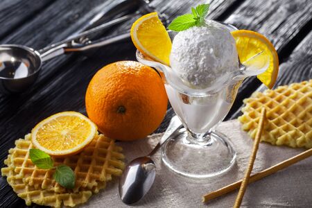 Ice Cream with orange, Mint and waffles. Homemade Organic product. On the white wooden table.の写真素材