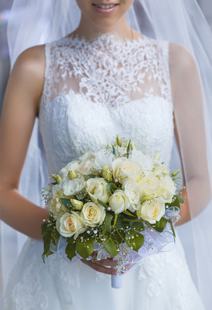 Bride in White Dress Holding Splendid Bridal Boquet Colorfulの写真素材