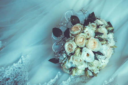 Bridal Boquet on the white wedding dress. close upの写真素材