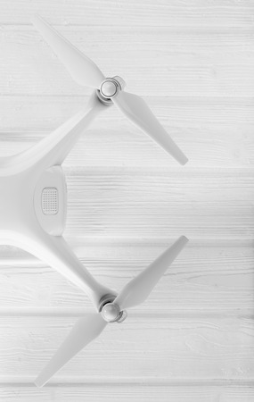 concept quadrocopter on a white wooden backgroundの写真素材