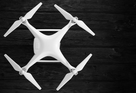concept quadrocopter on a black wooden backgroundの写真素材
