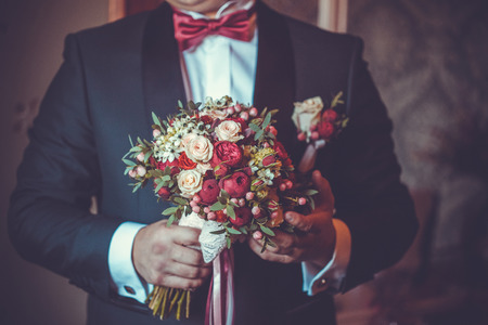 Concept image - groom waiting for bride with a bouquetの写真素材