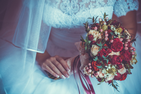 Bride in White Dress Holding Splendid Bridal Boquet Colorfulの写真素材