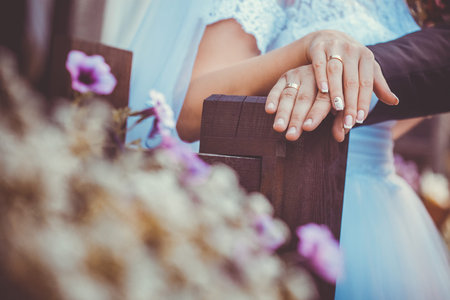 Bride and groom holding hands outdoors. close-upの写真素材