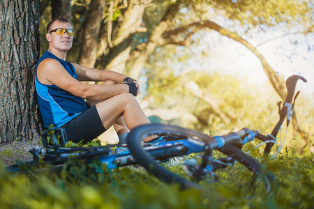 Mountain biking - man with bike enjoy summer vacationの写真素材
