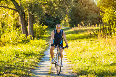 Mountain biking - man with bike enjoy summer vacationの写真素材