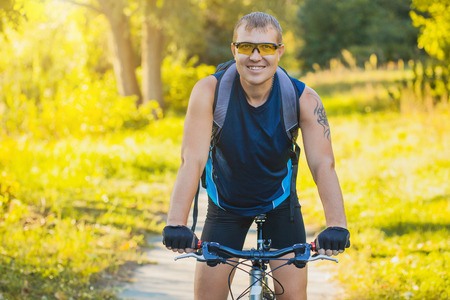 Mountain biking - man with bike enjoy summer vacationの写真素材