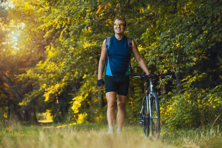 Mountain biking - man with bike enjoy summer vacationの写真素材