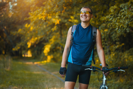 Mountain biking - man with bike enjoy summer vacationの写真素材