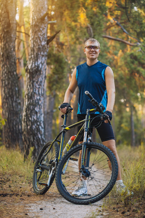 Mountain biking - man with bike enjoy summer vacationの写真素材