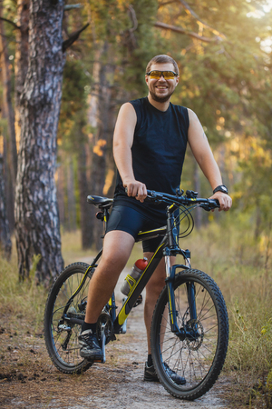 Mountain biking - man with bike enjoy summer vacationの写真素材