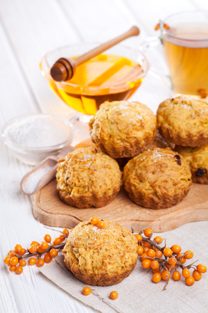 muffins with tea and honey on the white wooden backgroundの写真素材