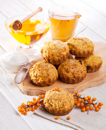 muffins with tea and honey on the white wooden backgroundの写真素材