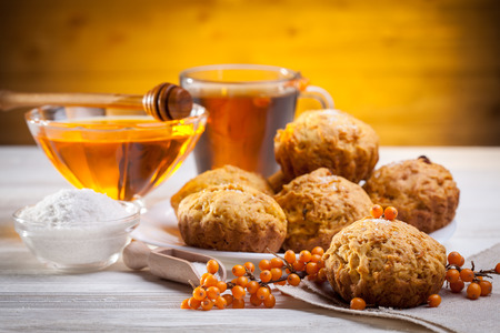 muffins with tea and honey on the white wooden backgroundの写真素材