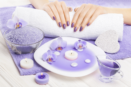 beautiful blue manicure with decor, orchid, towel and candles on the white wooden table. spaの写真素材