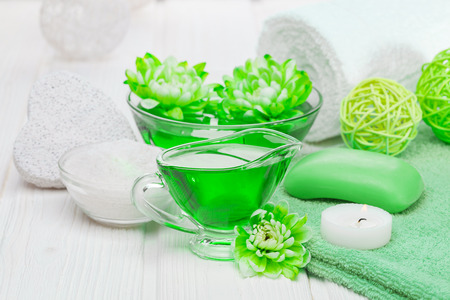 Spa still life of sea salt and essential oils and green chrysanthemum flowersの写真素材