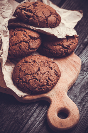 chocolate cookies with chocolate on wooden backgroundの写真素材