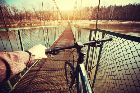 Man riding on a bicycle in summer near the lakeの写真素材