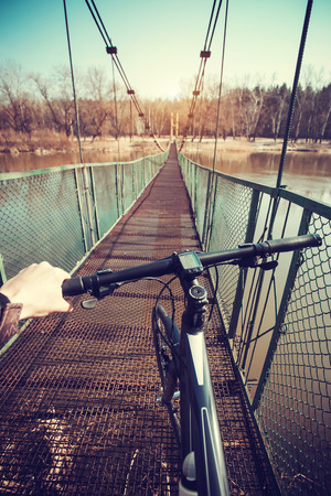 Man riding on a bicycle in summer near the lakeの写真素材