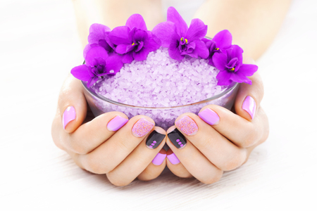 beautiful purple manicure with violet, candle and sea salt on the white wooden table. spaの写真素材