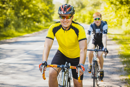 bikers on a summer workout on a forest road. sports, recreationの写真素材
