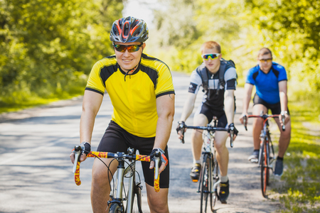 bikers on a summer workout on a forest road. sports, recreationの写真素材