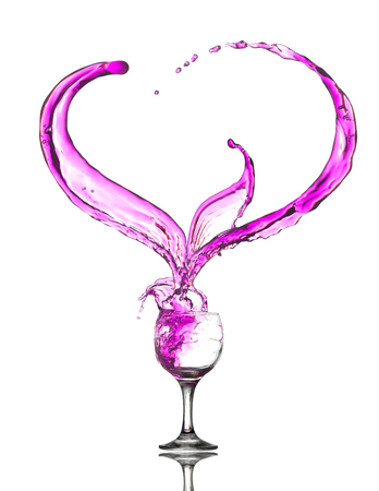 A glass of pink wine. Heart Splash. Isolated on the whiteの写真素材
