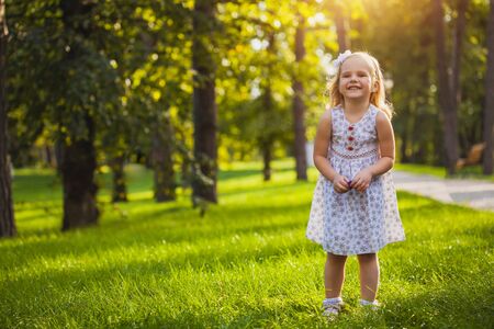 girl playing in the sunny summer parkの写真素材