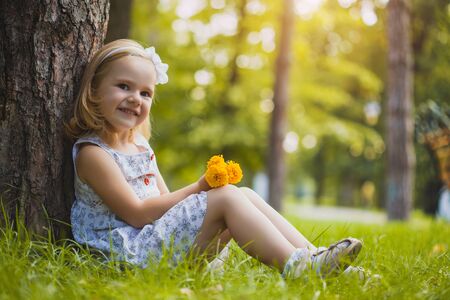 girl playing in the sunny summer parkの写真素材
