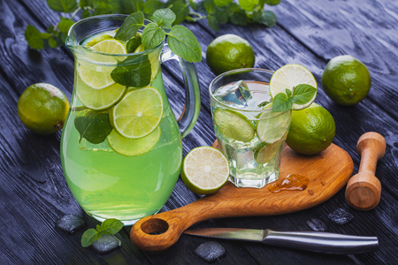 lemonade mojito in a glass on a black wooden backgroundの写真素材
