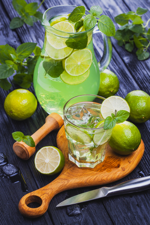 lemonade mojito in a glass on a black wooden backgroundの写真素材