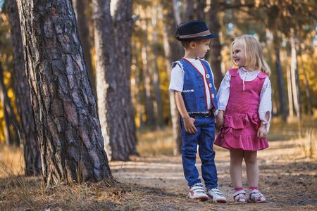 Funny children are playing in the park. A boy and a girl. Carefree childhoodの写真素材