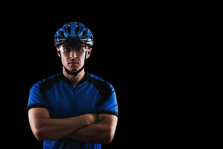 handsome cyclist portrait on a black backgroundの写真素材