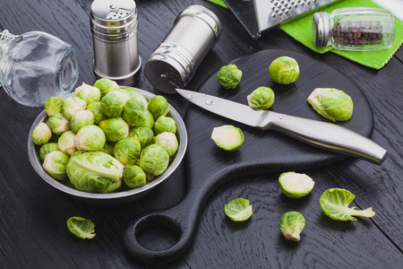 fresh raw brussels sprouts on a black wooden table.の写真素材