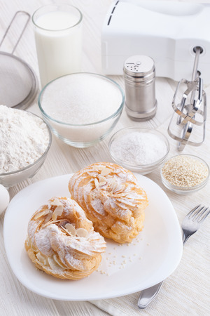 Ingredients for baking delicious cakes on a white wooden tableの写真素材