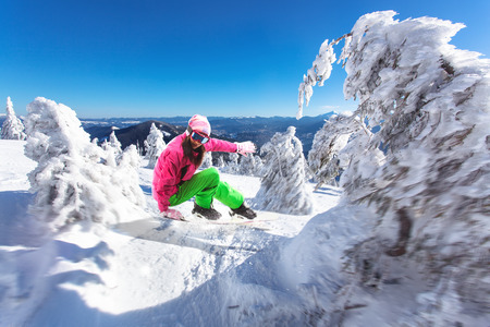 woman snowboarder skiing in the mountainsの写真素材