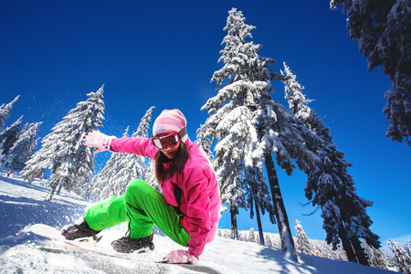 woman snowboarder skiing in the mountainsの写真素材
