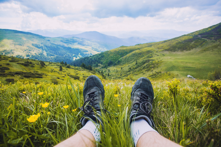 hiking boots having fun and enjoying wonderful breathtaking mountain view. Carpathian mountainsの写真素材
