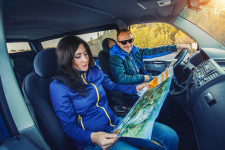 young couple traveling by car through the picturesque autumn forest.の写真素材