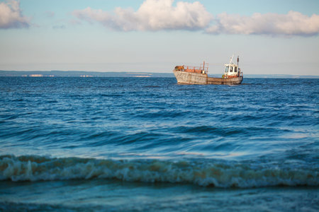 old fishing boat going on the sea waves