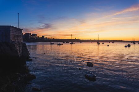 Yacht at sunrise in ocean bayの写真素材